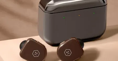 Wireless earbuds sitting beside their charging case