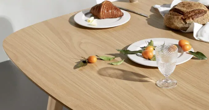 Breakfast laid out on a light wooden dining table