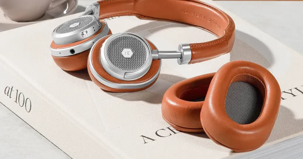 Premium over-ear headphones resting on a coffee table book